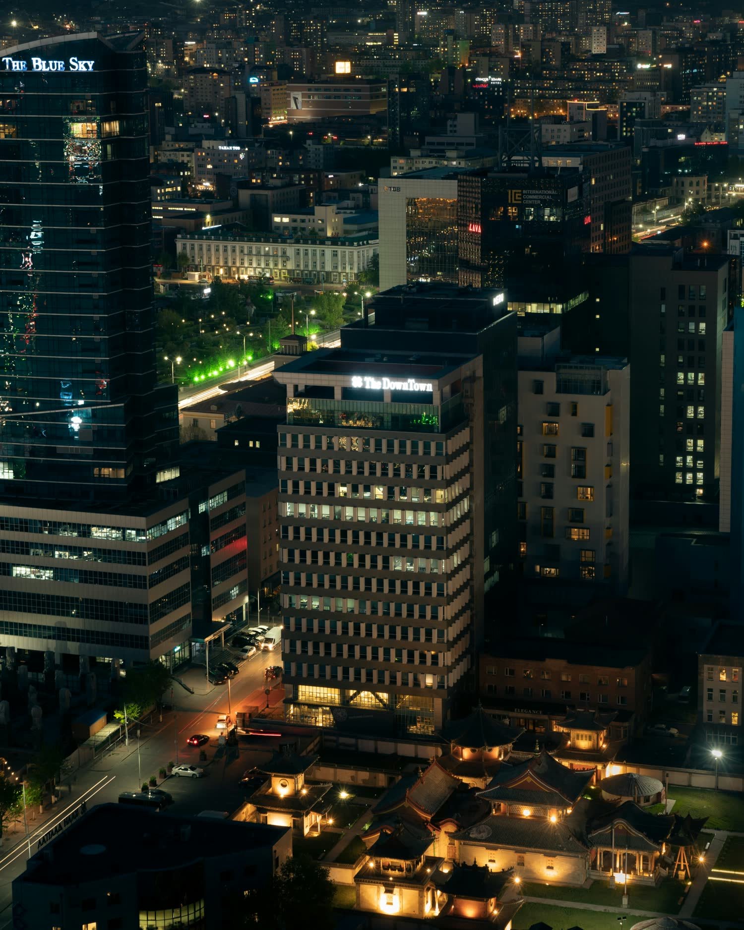 A developed city skyline at night, the infrastructure a resilient layer protects