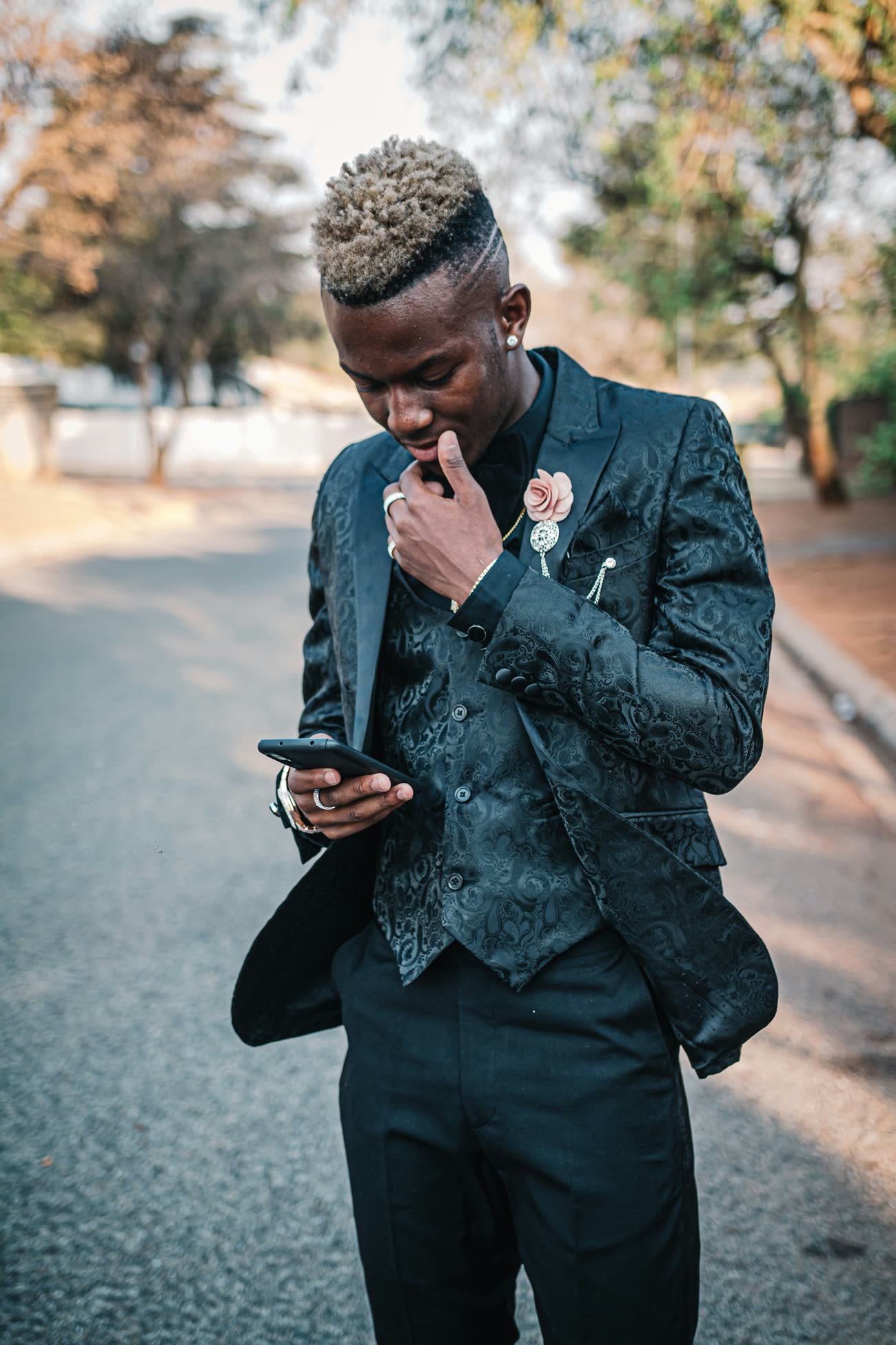 A man outdoors using a mobile phone to reach markets and services beyond his village
